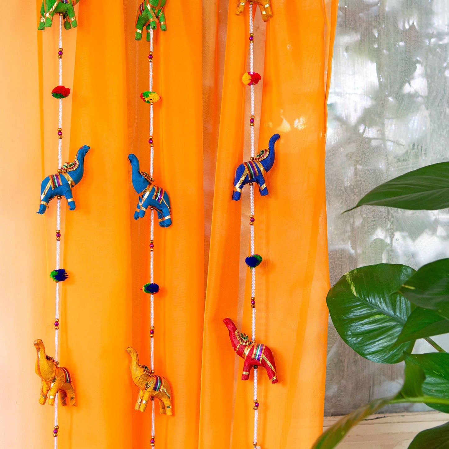 String of Elephants with Bell